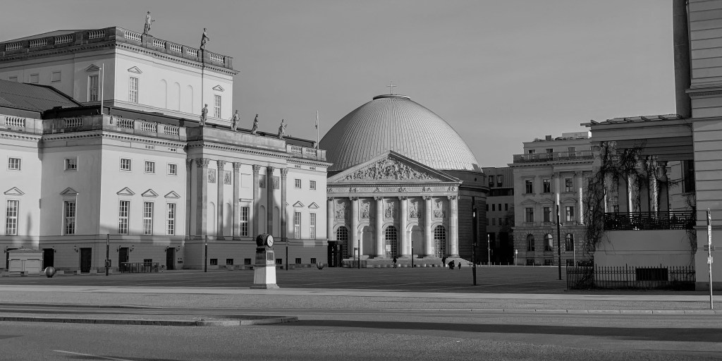Berlin cultural buildings and open square seen across an empty road during lockdown.