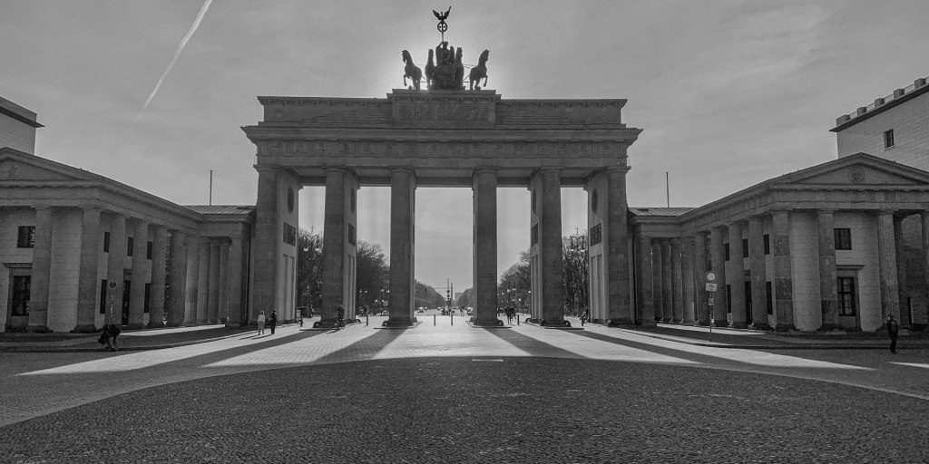 Brandenburg Gate in Berlin seen from a low angle, with an almost empty square beneath it.