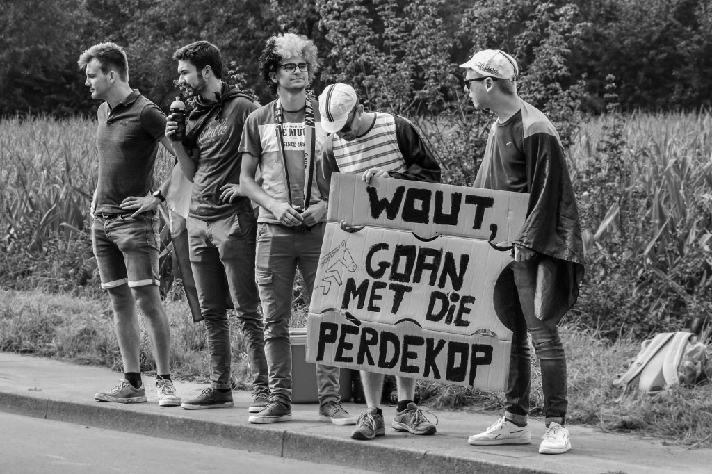 Spectators beside the road holding a handmade sign supporting Wout van Aert during the UCI Road World Championships in Leuven.